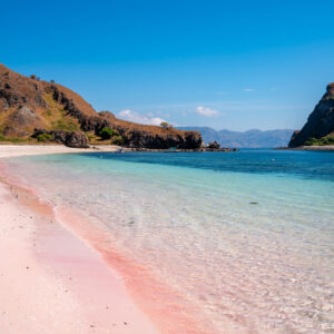 Tropical pink sandy beach with clear turquoise water at Komodo islands in Indonesia